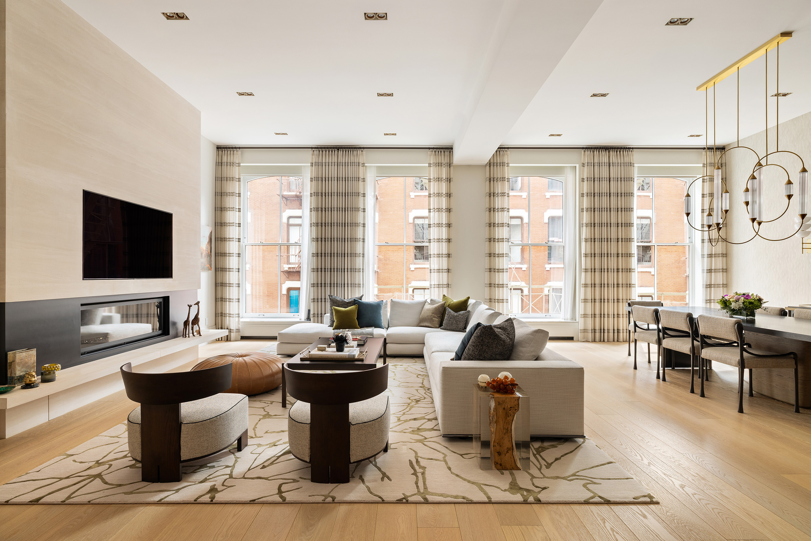 53 Greene Street, Unit 3 Manhattan, NY 10013 - Photo 1 of 22 a living room with patio furniture and a flat screen tv
