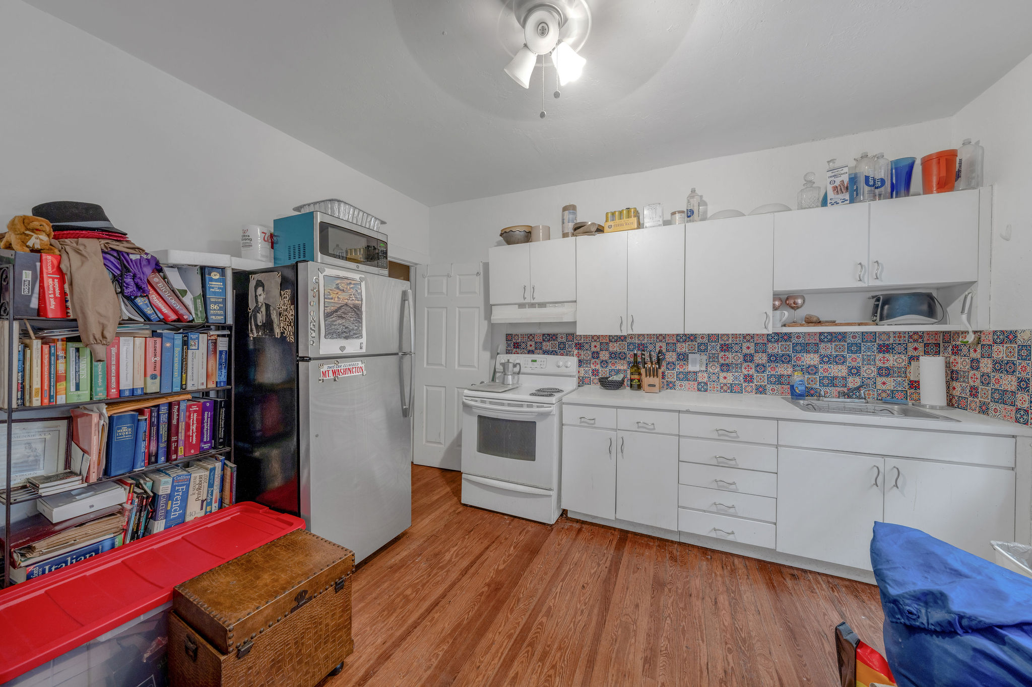 735-745 Meridian Avenue Miami Beach, FL 33139 - Photo 23 of 62 a kitchen with stainless steel appliances granite countertop a refrigerator and a wooden cabinets