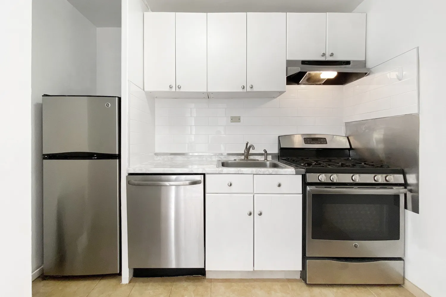 a kitchen with stainless steel appliances granite countertop a refrigerator stove a sink and dishwasher