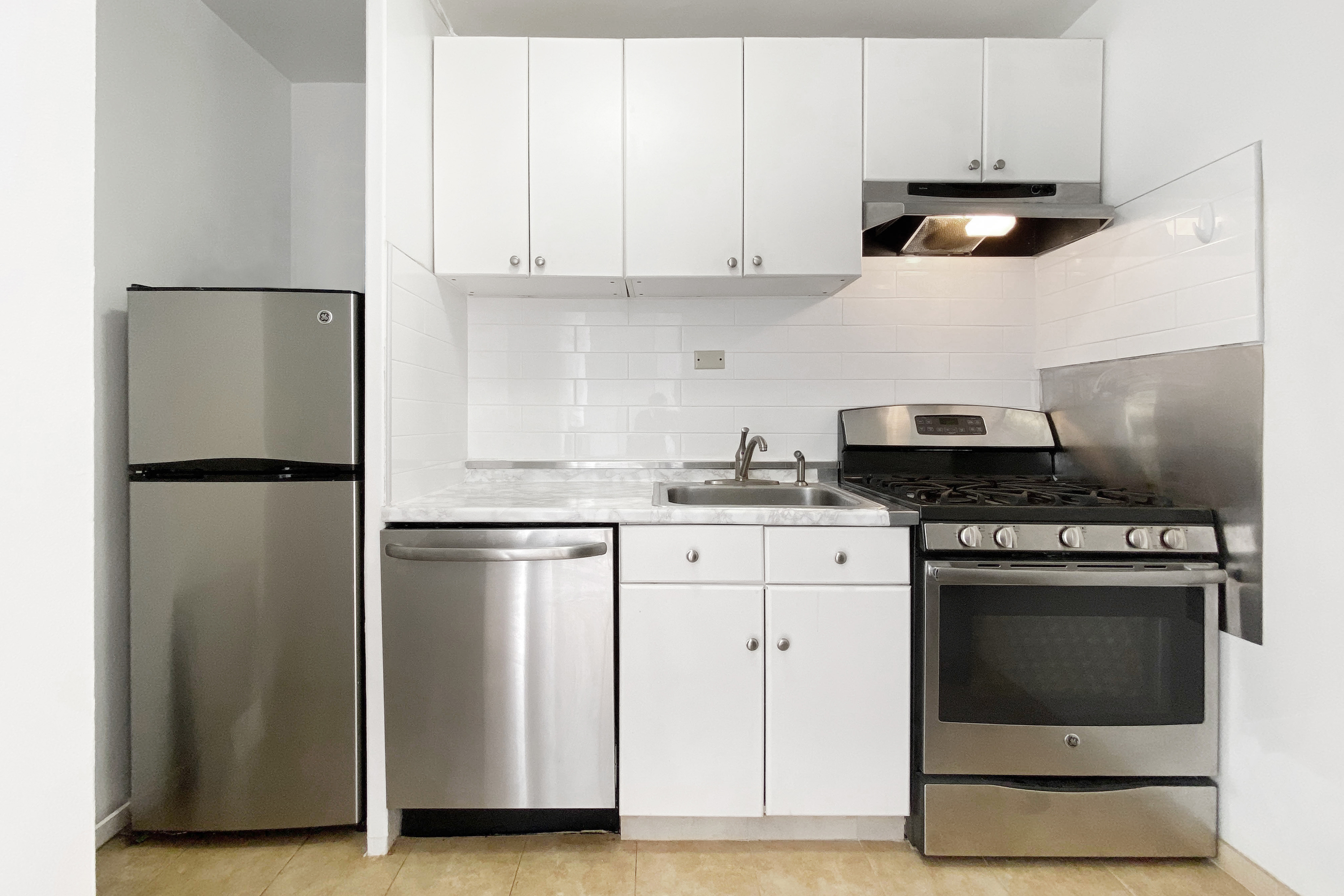 343 East 30th Street, Unit 21G Manhattan, NY 10016 - Photo 5 of 15 a kitchen with stainless steel appliances granite countertop a refrigerator stove a sink and dishwasher