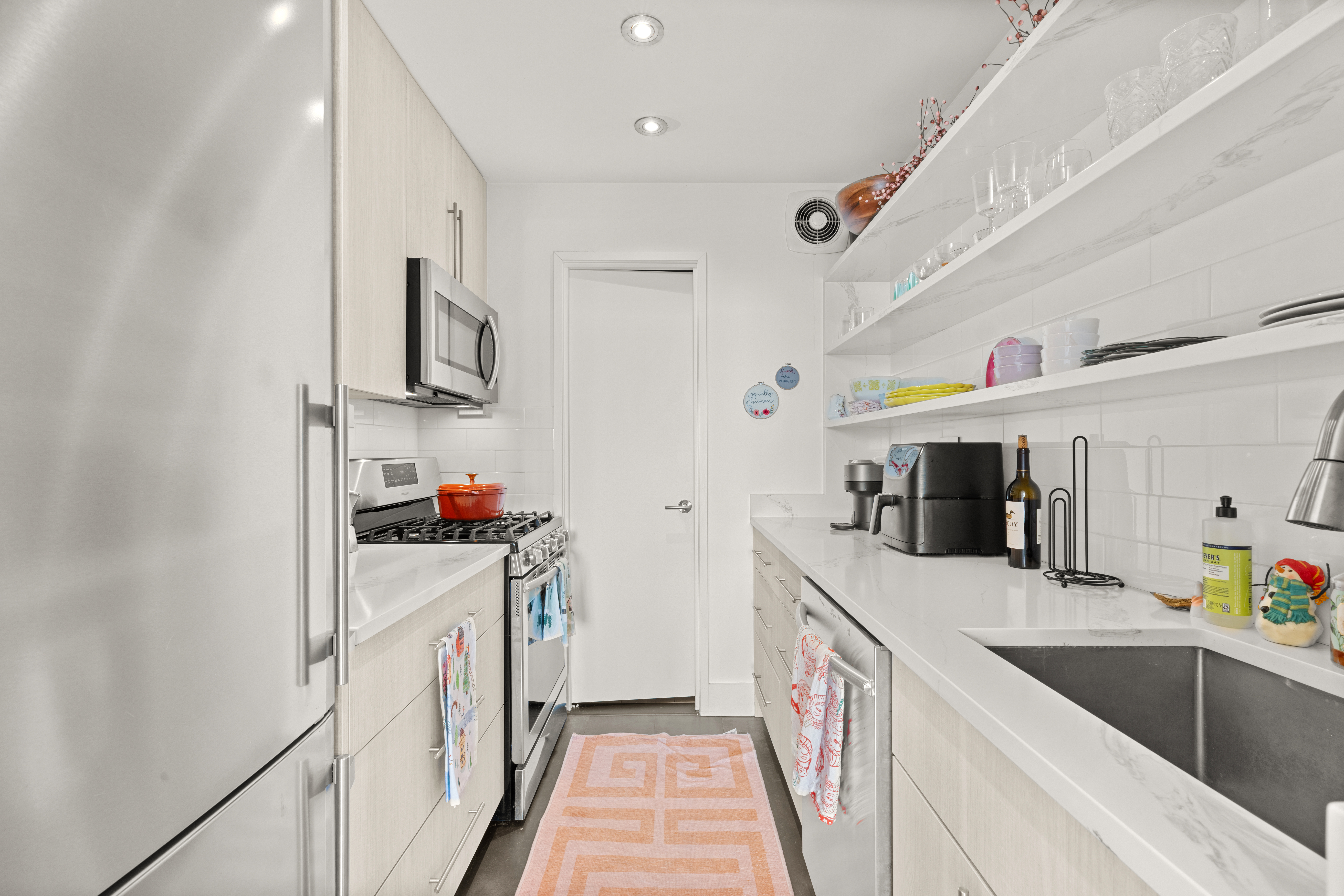310 East 46th Street, Unit 22U Manhattan, NY 10017 - Photo 7 of 9 a utility room with stainless steel appliances granite countertop a sink and dishwasher