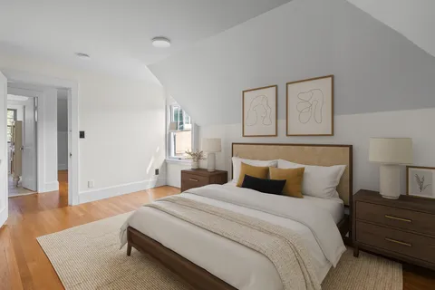 a bedroom with a bed and a night stand