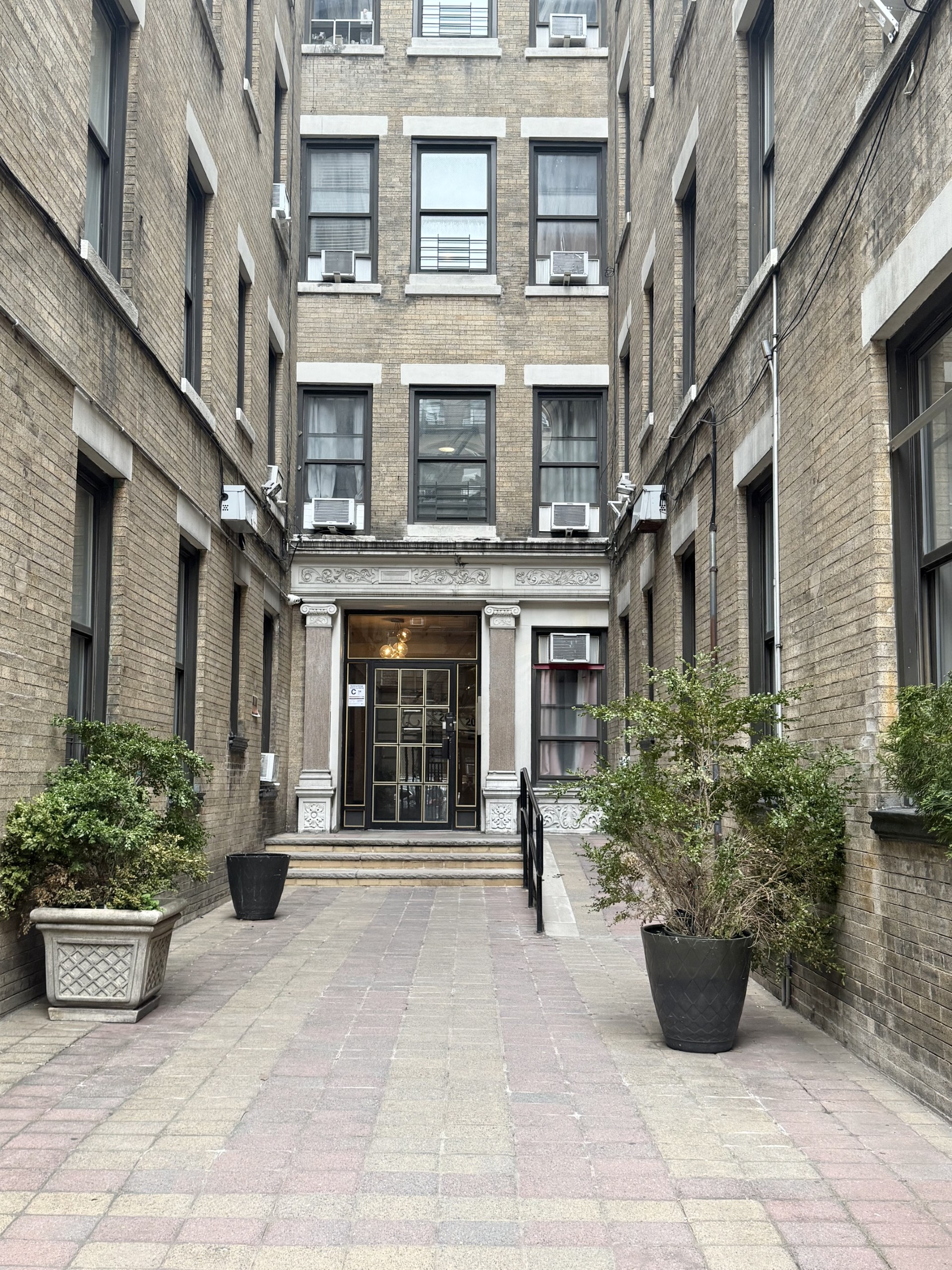 205 West 103rd Street, Unit 3A Manhattan, NY 10025 - Photo 8 of 9 a view of a building with potted plants