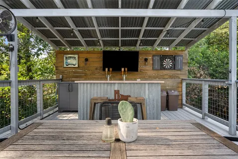 a roof deck with table and chairs potted plants with wooden floor