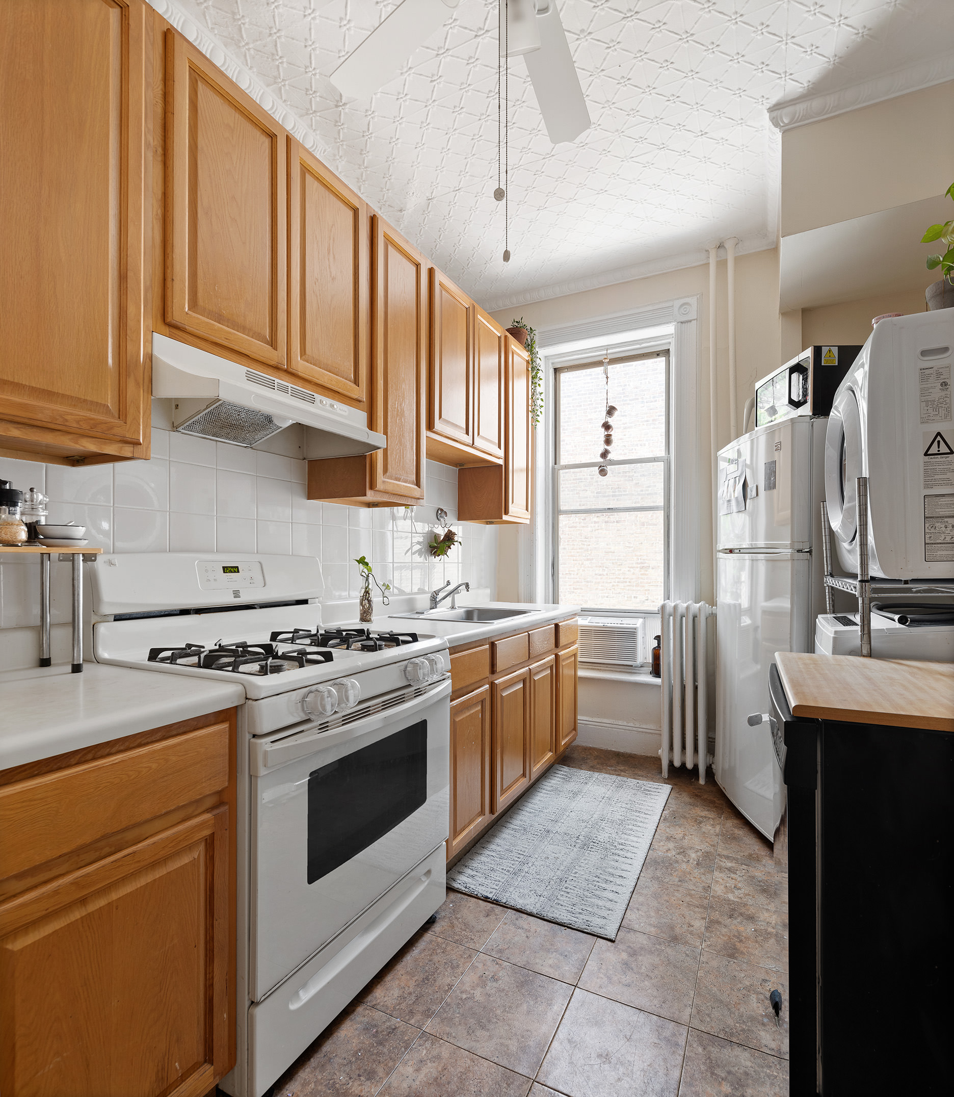 80 7th Avenue Brooklyn, NY 11217 - Photo 5 of 8 a kitchen with a stove a sink and a refrigerator
