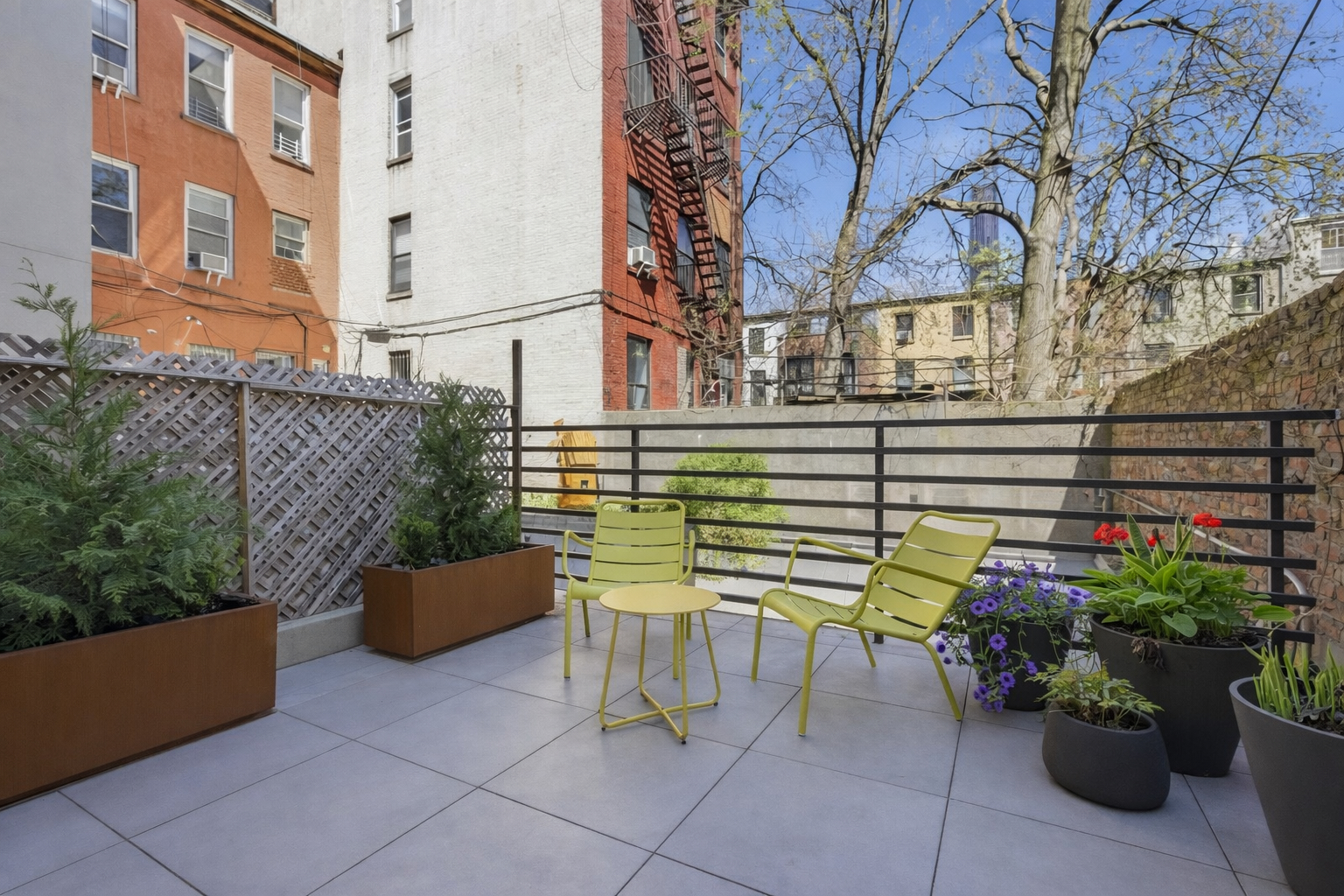 433 Warren Street, Unit 2C Brooklyn, NY 11217 - Photo 8 of 19 a view of a chairs and table in the back yard of the building