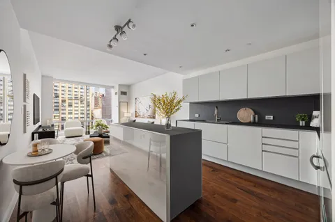 a kitchen with a table chairs stove and cabinets