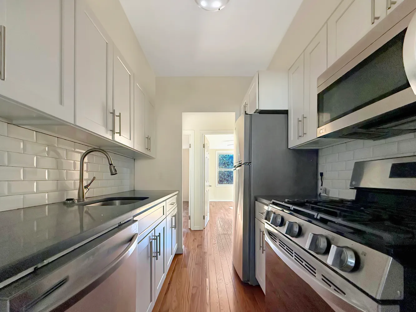 a kitchen with stainless steel appliances granite countertop a stove and a refrigerator