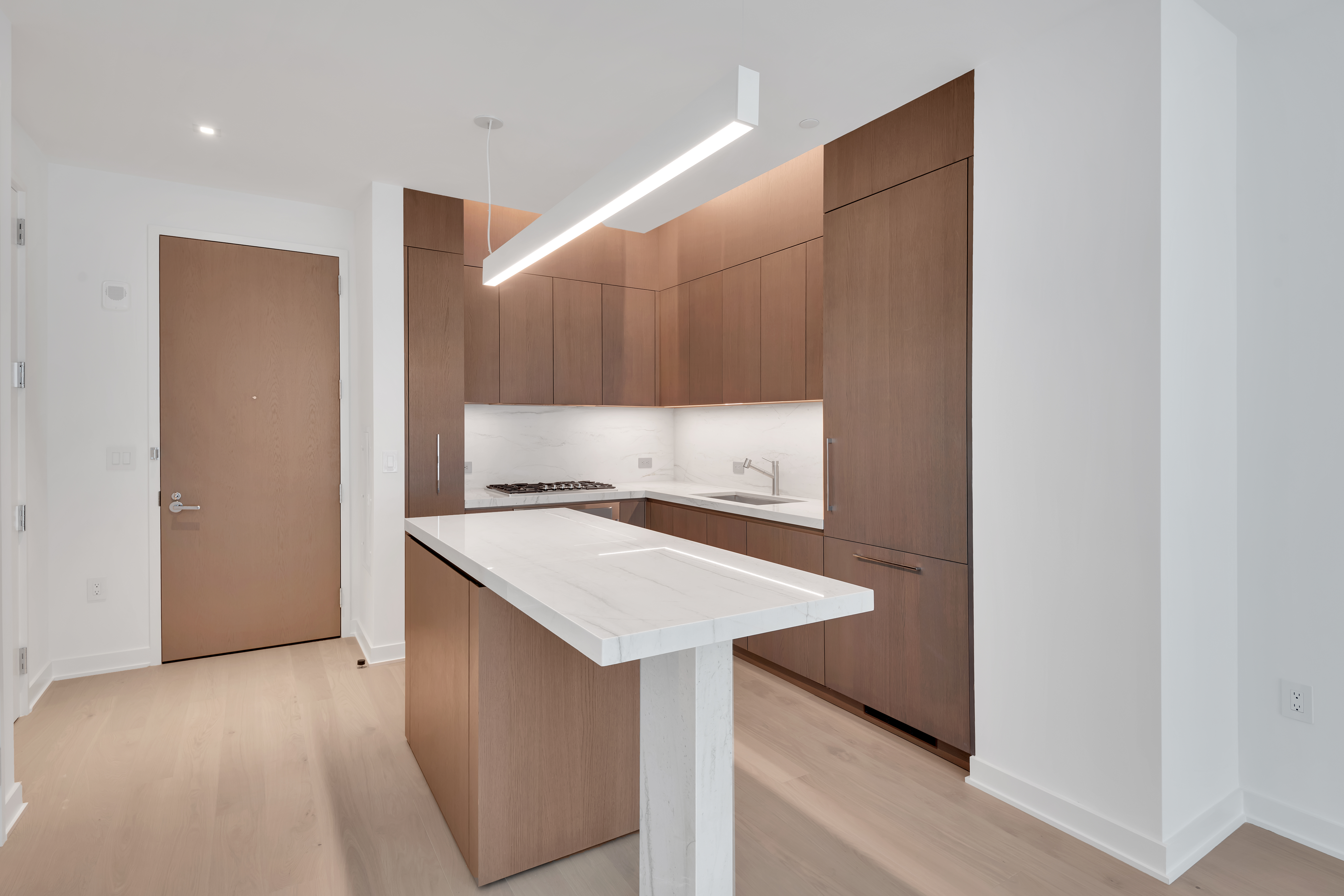 77 Charlton Street, Unit S11G Manhattan, NY 10014 - Photo 2 of 9 a kitchen with a sink cabinets and wooden floor
