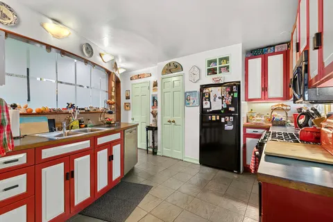 a kitchen with stainless steel appliances granite countertop a refrigerator and a stove top oven
