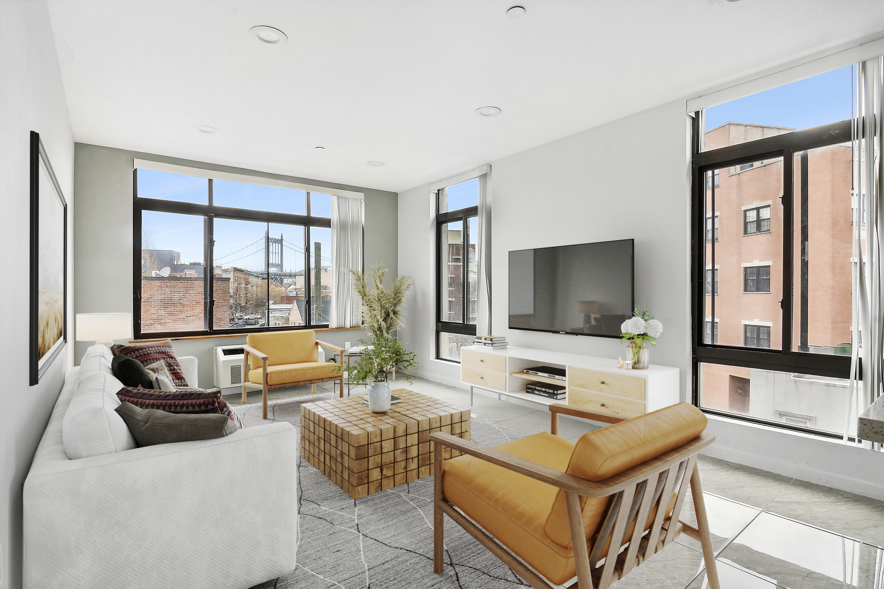 27-16 18th Street, Unit 2 Queens, NY 11102 - Photo 1 of 6 a living room with furniture and a flat screen tv