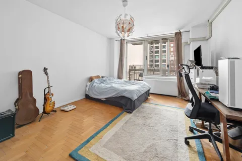 a bedroom with a bed and a book shelf