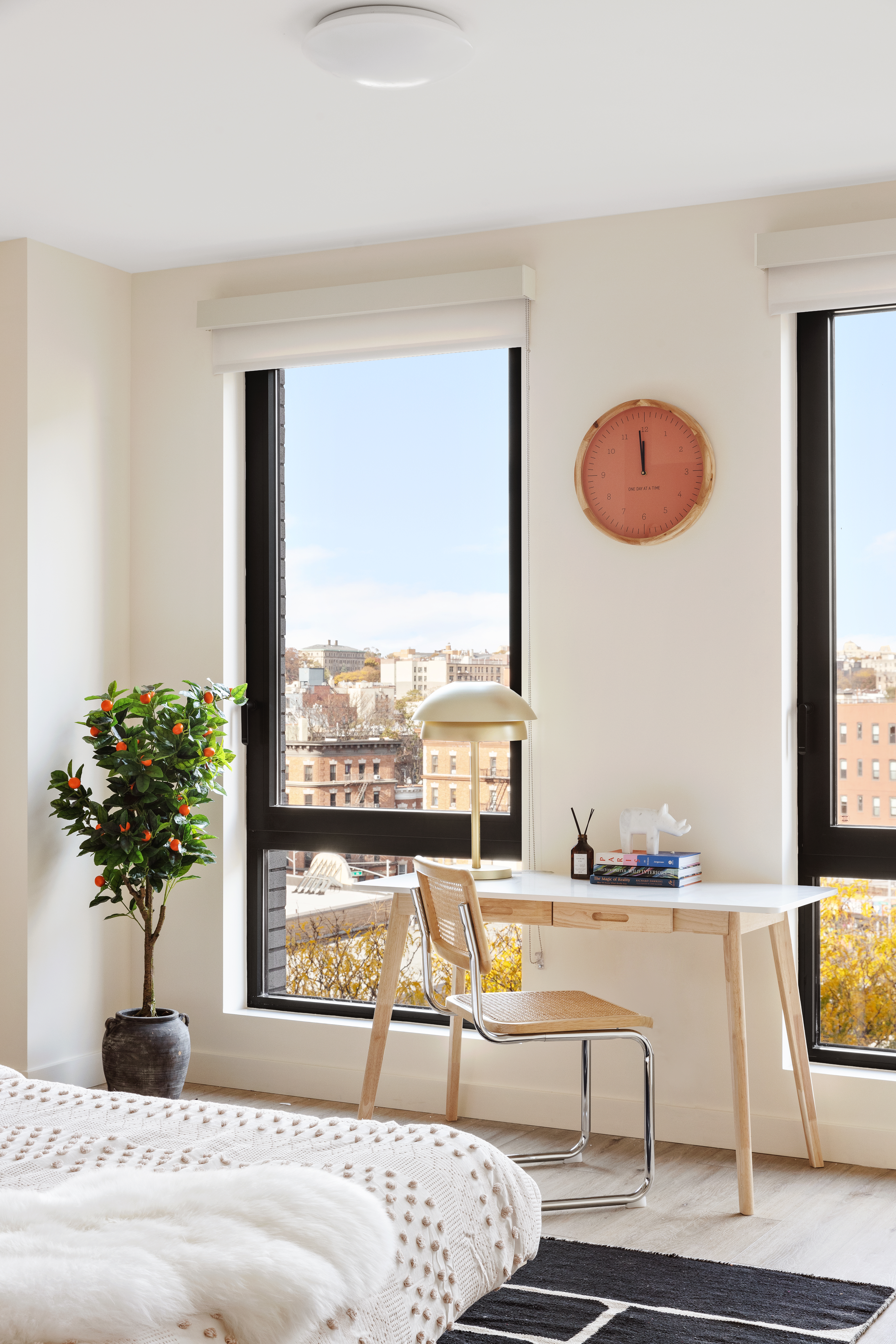 130 East 177th Street, Unit 8A Bronx, NY 10453 - Photo 5 of 16 a living room with a large window and a potted plant