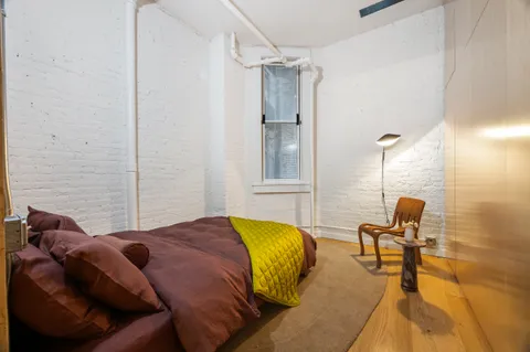 a view of a workspace with furniture and window