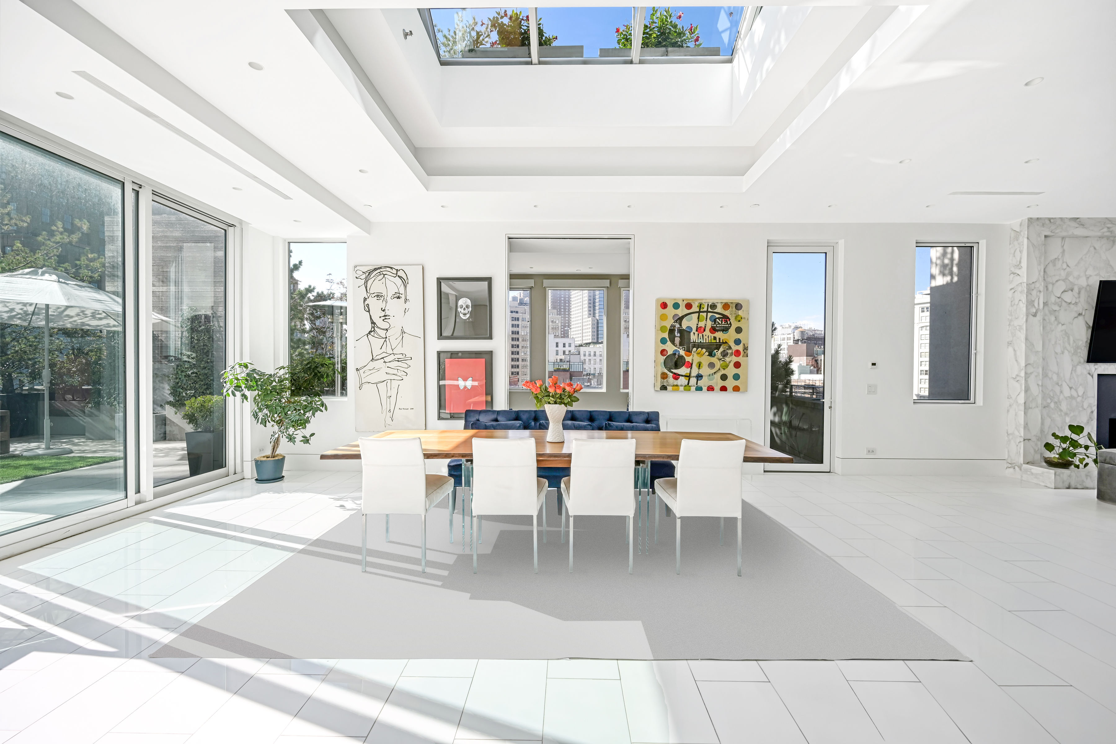 53 Leonard Street, Unit PH Manhattan, NY 10013 - Photo 2 of 24 a living room with furniture a large window and potted plants