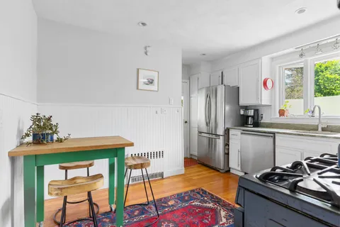 a kitchen with stainless steel appliances a stove a sink and a refrigerator