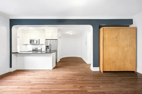 a view of kitchen and hall with wooden floor