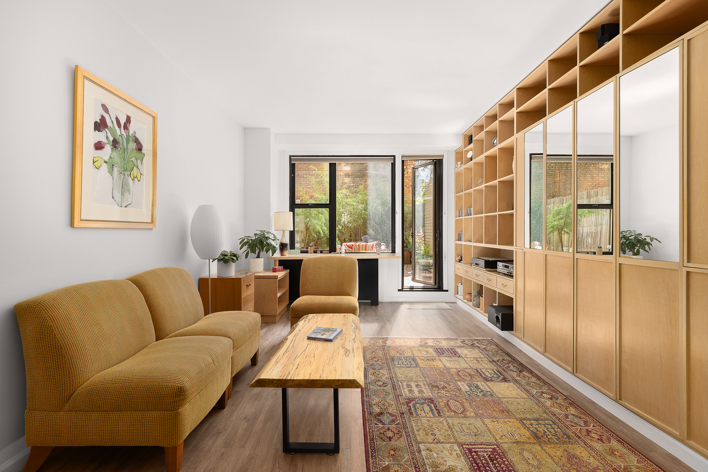 a living room with furniture and a floor to ceiling window