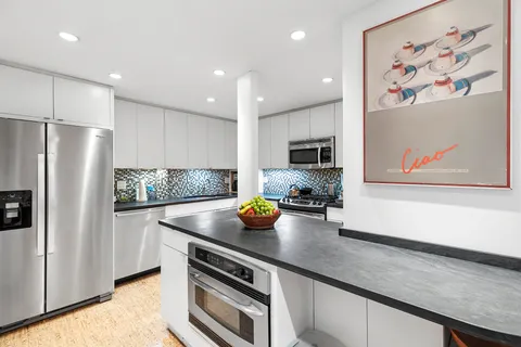 a kitchen with stainless steel appliances a stove a sink and a refrigerator