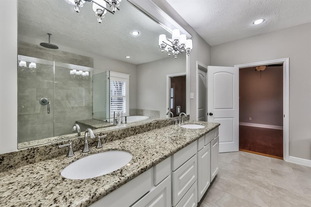 1120 Winston Street Houston, TX 77009 - Photo 22 of 29 a bathroom with a granite countertop double vanity sink and a mirror