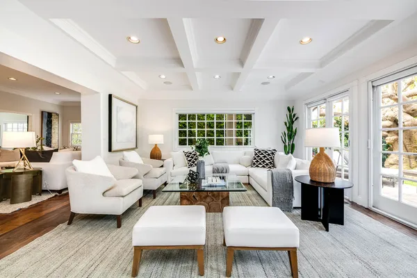 a living room with furniture fireplace and wooden floor