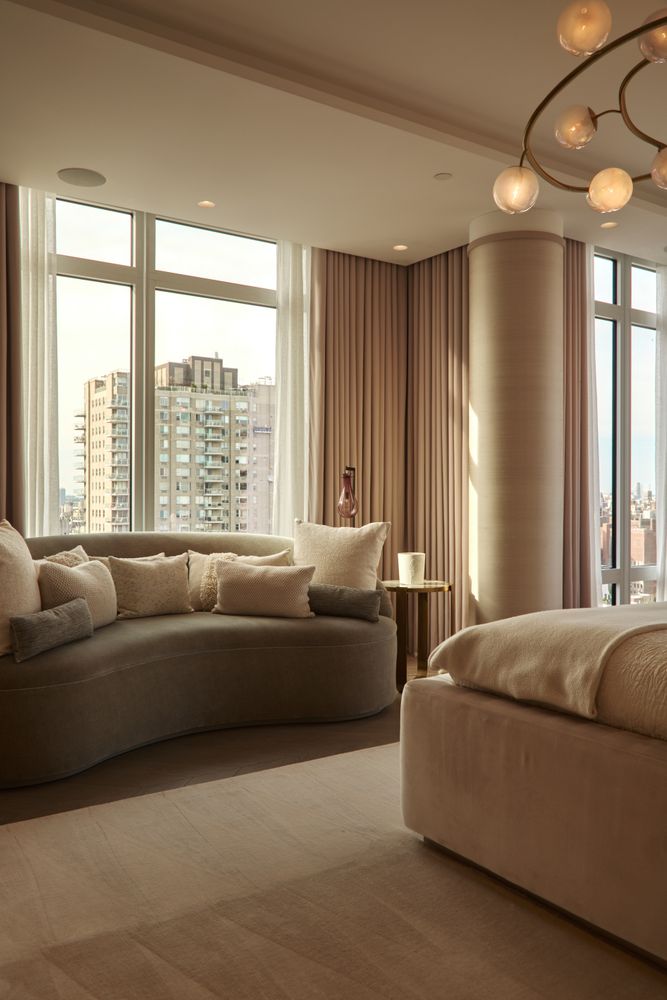 a living room with furniture and large windows