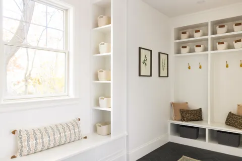 a bathroom with a window and a potted plant