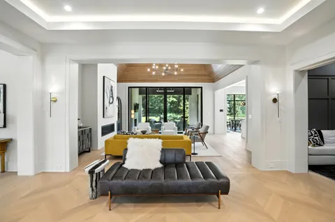 a living room with furniture and large windows