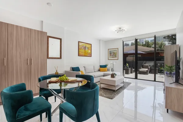 a living room with furniture and a potted plant
