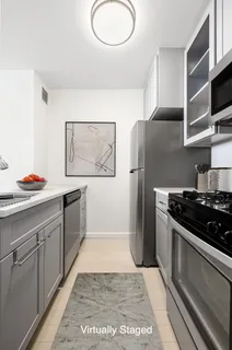 a kitchen with stainless steel appliances granite countertop a refrigerator and a stove