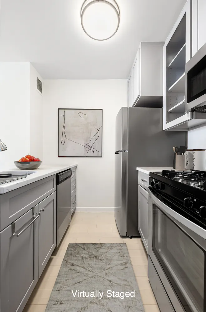 a kitchen with stainless steel appliances granite countertop a refrigerator and a stove