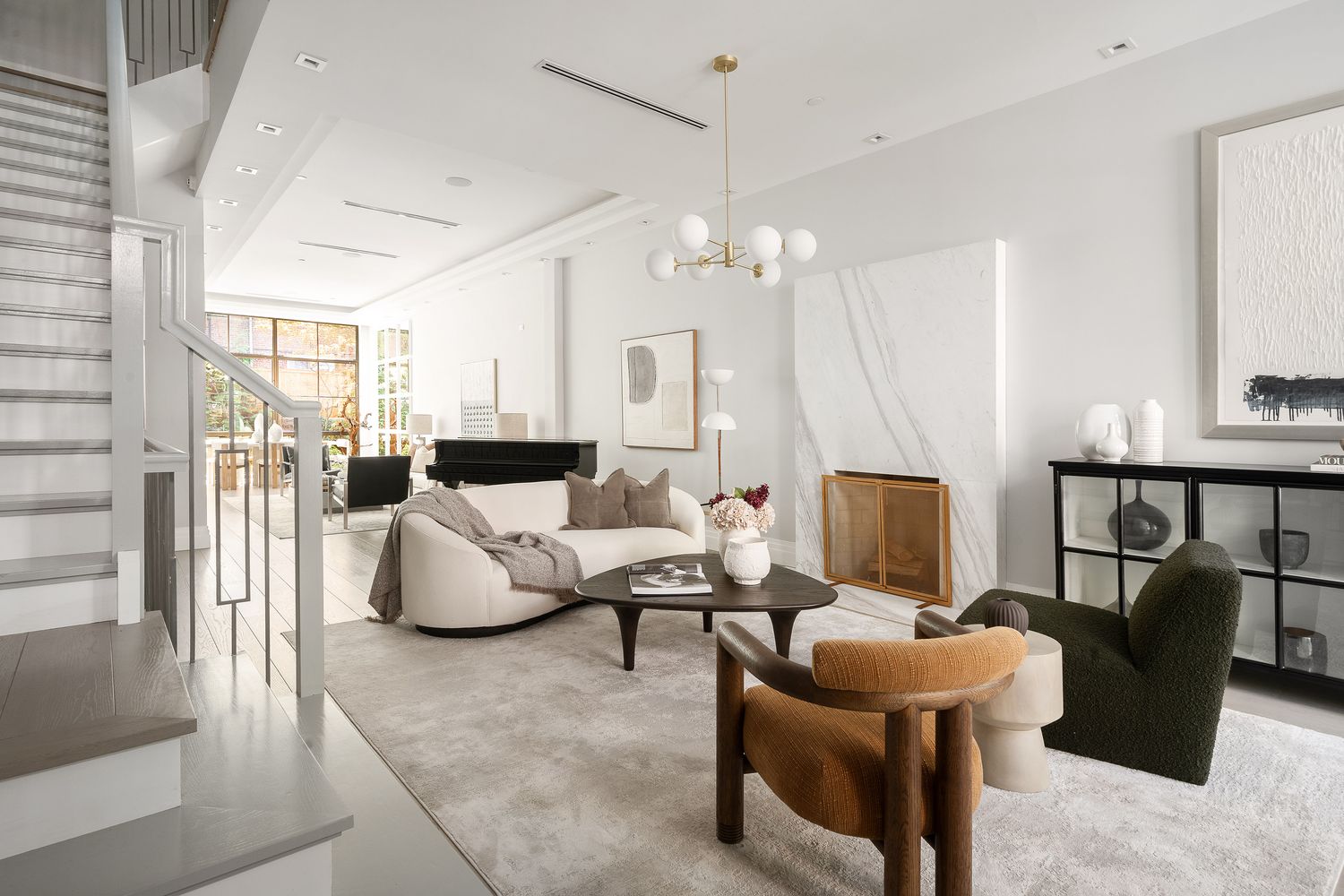 520 East 89th Street Manhattan, NY 10128 - Photo 29 of 40 a living room with furniture and a chandelier