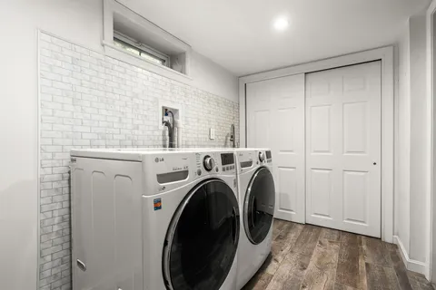 a view of a storage & utility room with dryer and washer