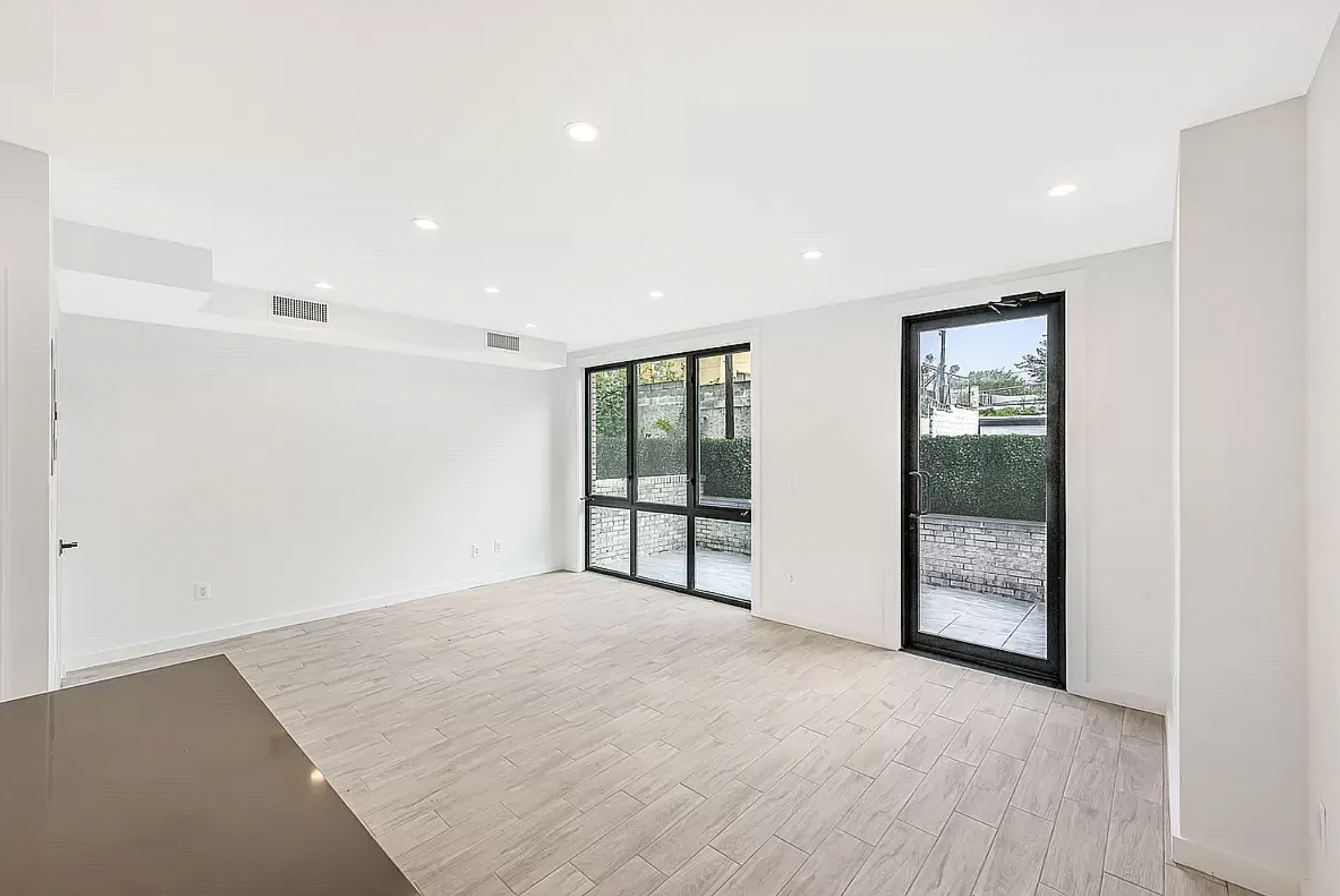 14-11 31st Avenue, Unit 1B Queens, NY 11106 - Photo 2 of 9 a view of an empty room with glass door