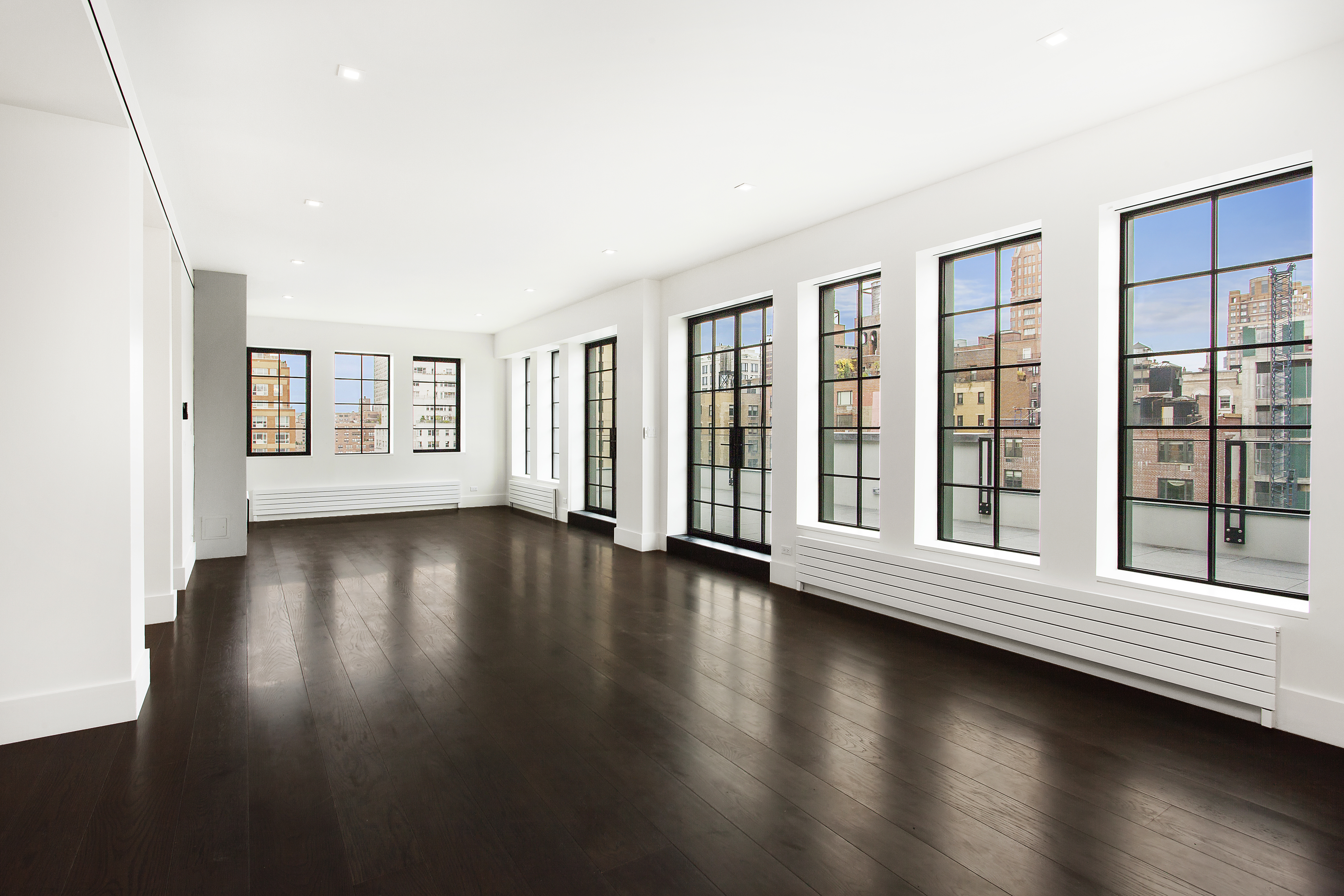 East 80th Street Manhattan, NY 10075 - Photo 1 of 13 a view of an empty room with wooden floor and a window