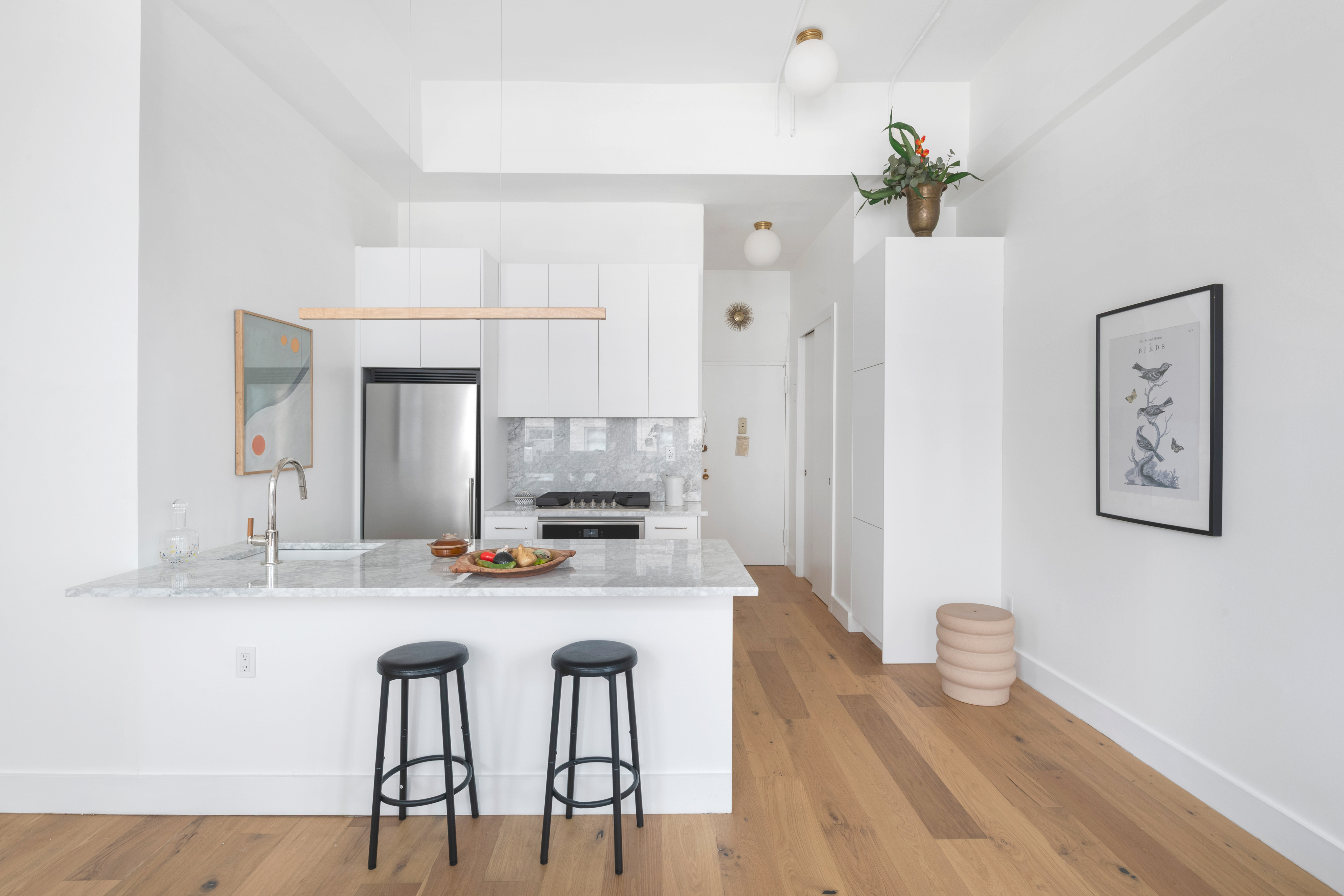 96 Schermerhorn Street, Unit 11F Brooklyn, NY 11201 - Photo 3 of 13 a kitchen with stainless steel appliances a dining table chairs and chandelier