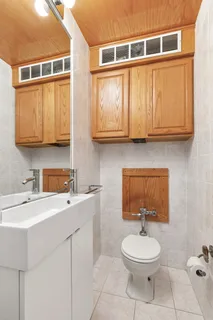 a bathroom with a sink a toilet and mirror