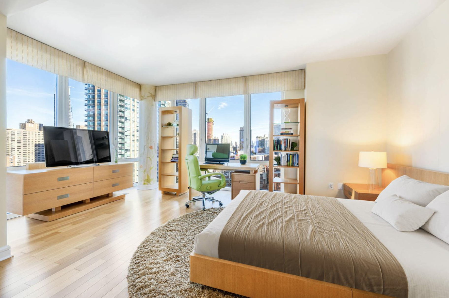 80 Riverside Boulevard, Unit 23C Manhattan, NY 10069 - Photo 7 of 19 a spacious bedroom with a bed and large windows