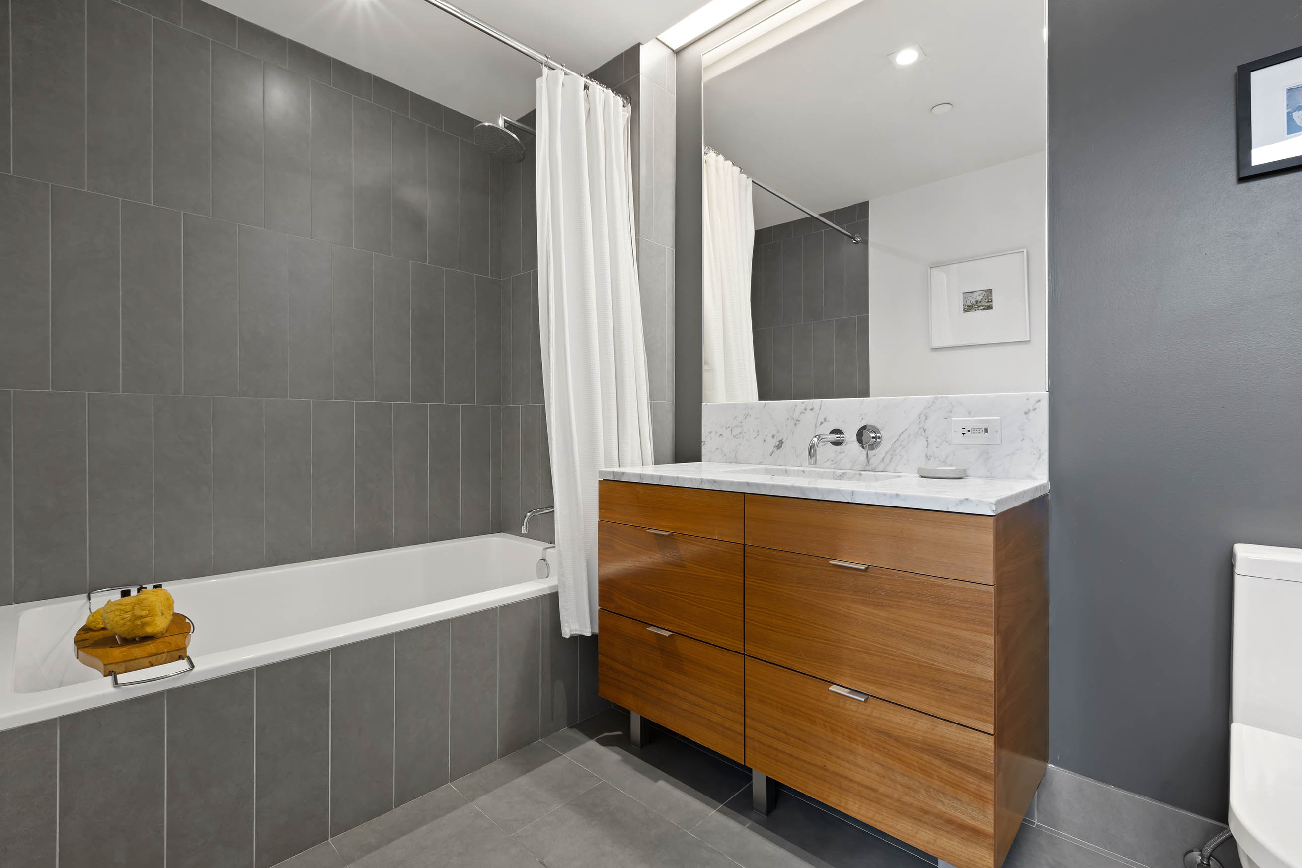 205 Water Street, Unit PHC Brooklyn, NY 11201 - Photo 10 of 14 a bathroom with a tub sink and mirror