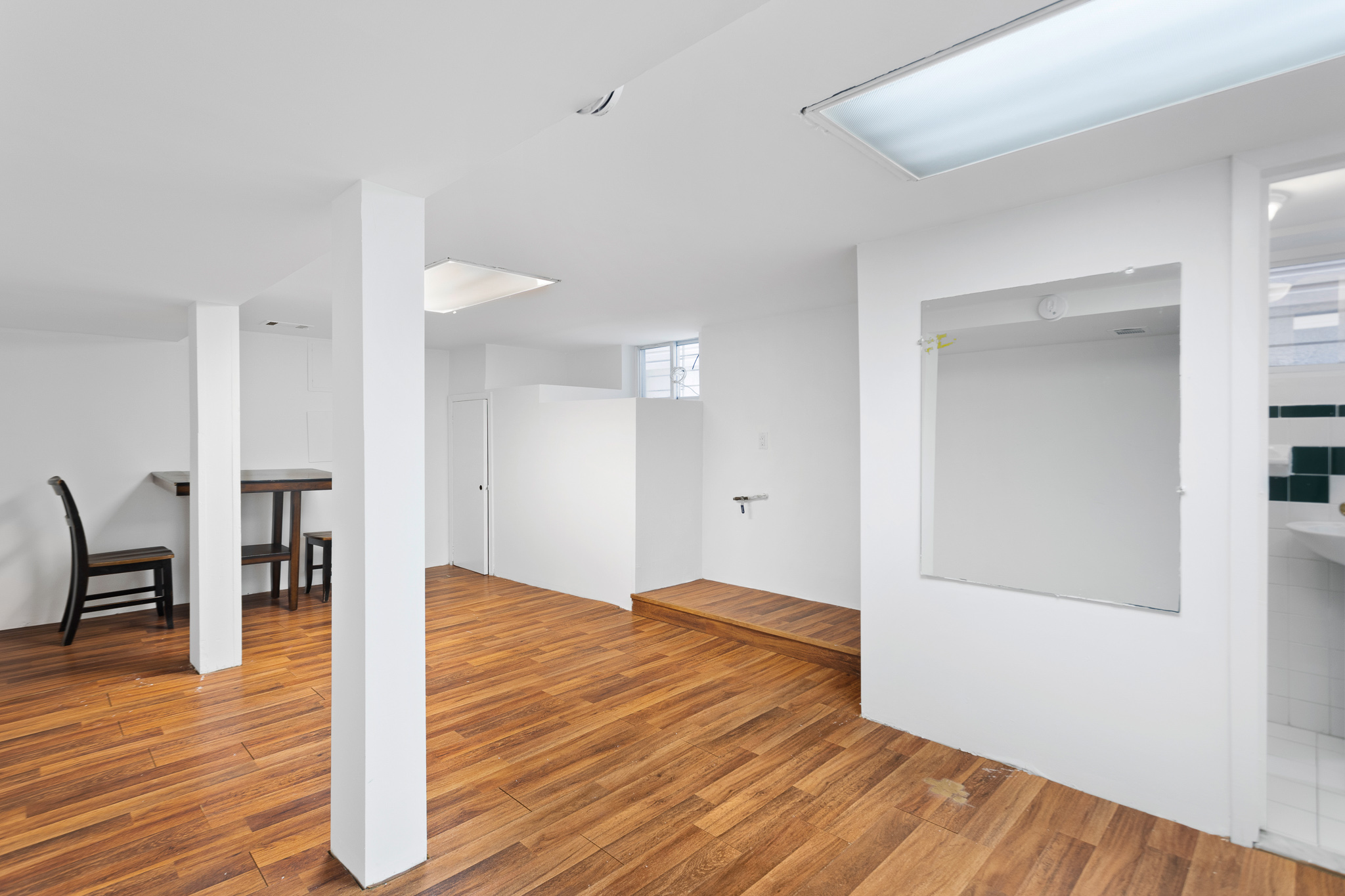 91-22 92nd Street Queens, NY 11421 - Photo 18 of 27 a view of empty room with wooden floor