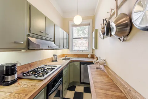 a kitchen with a sink stove and cabinets