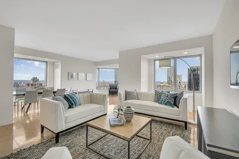 a living room with furniture and a large window