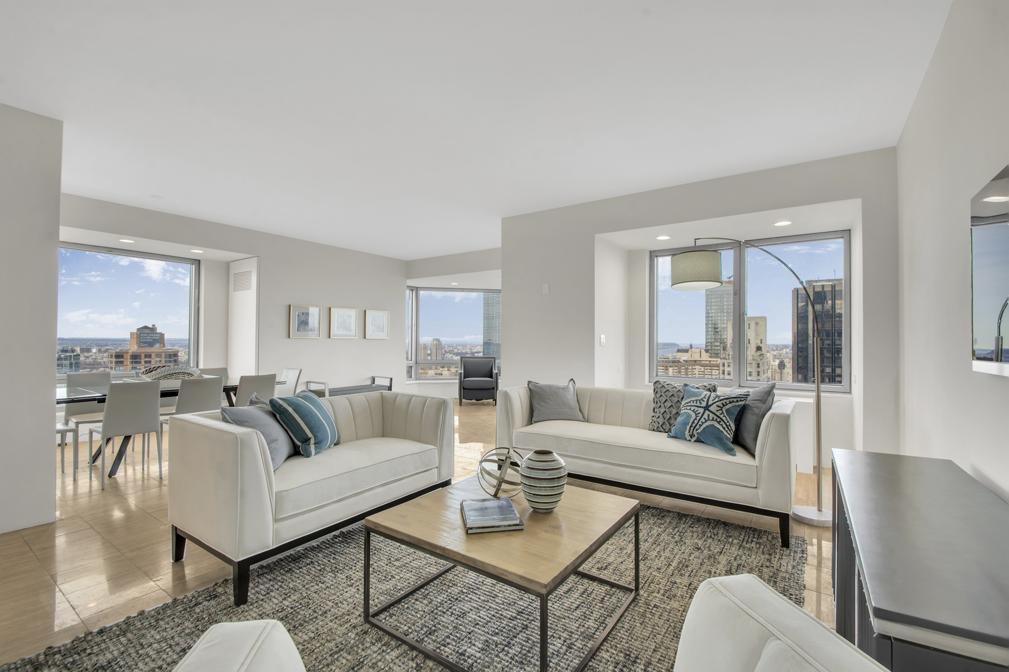 301 West 57th Street, Unit 48A Manhattan, NY 10019 - Photo 2 of 22 a living room with furniture and a large window