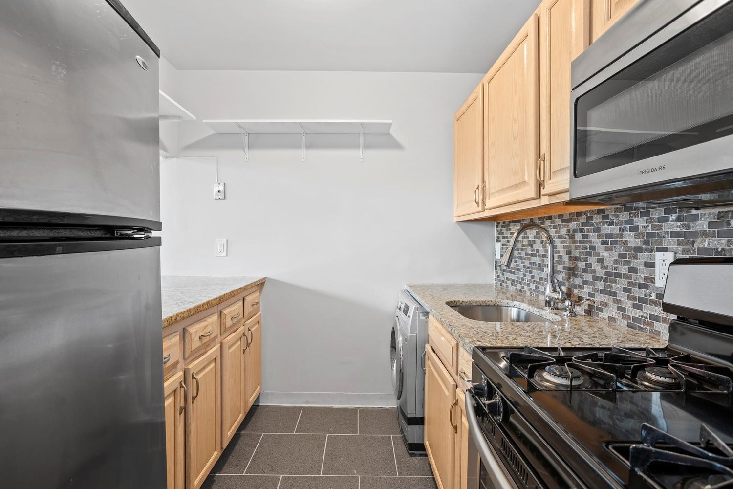 46 West 126th Street, Unit 3 Manhattan, NY 10027 - Photo 4 of 8 a kitchen with a stove and a microwave