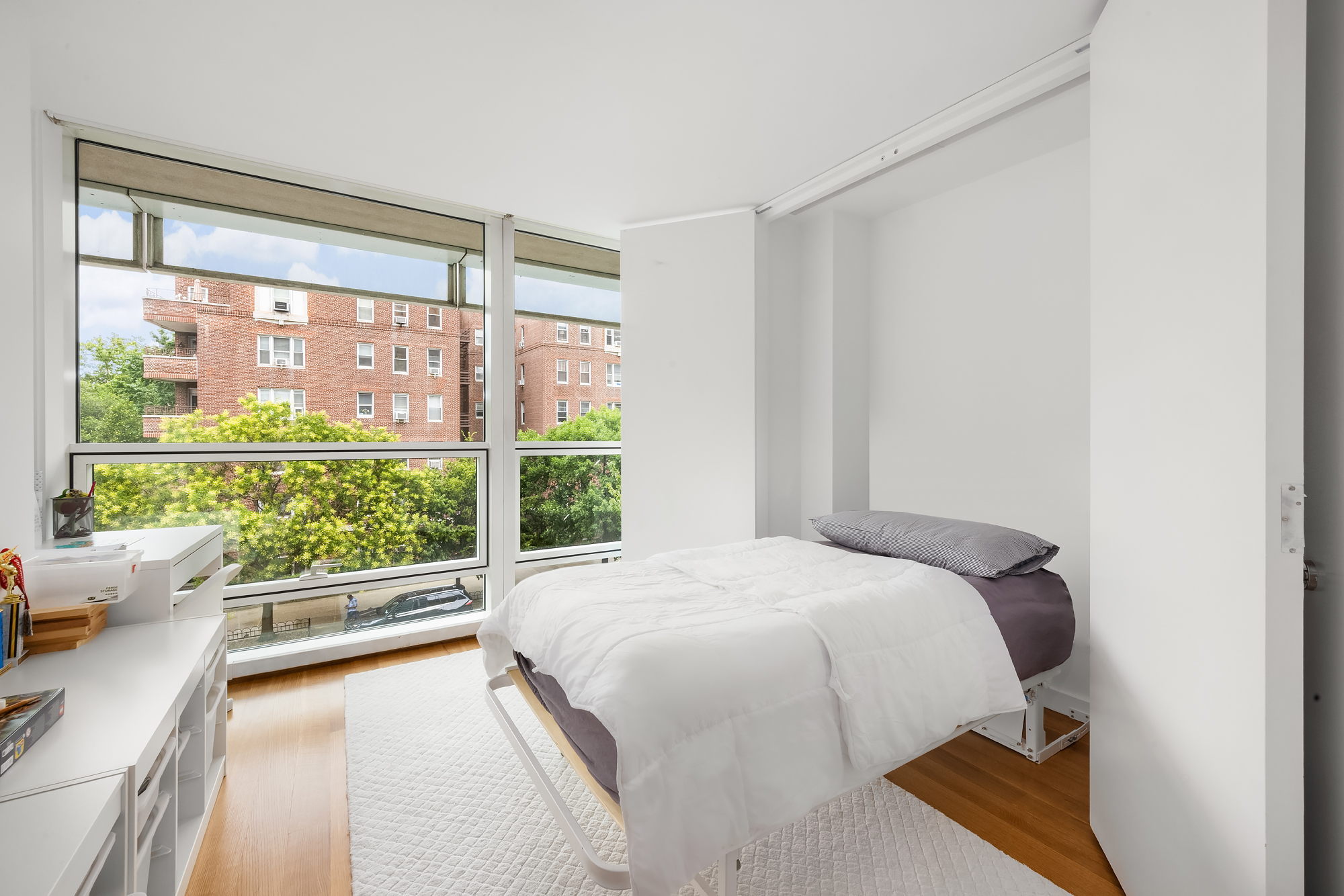 1 Grand Army Plaza, Unit 3C Brooklyn, NY 11238 - Photo 16 of 23 a bedroom with a bed and a large window