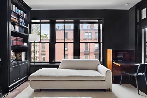 a large bedroom with a large bed and a large window