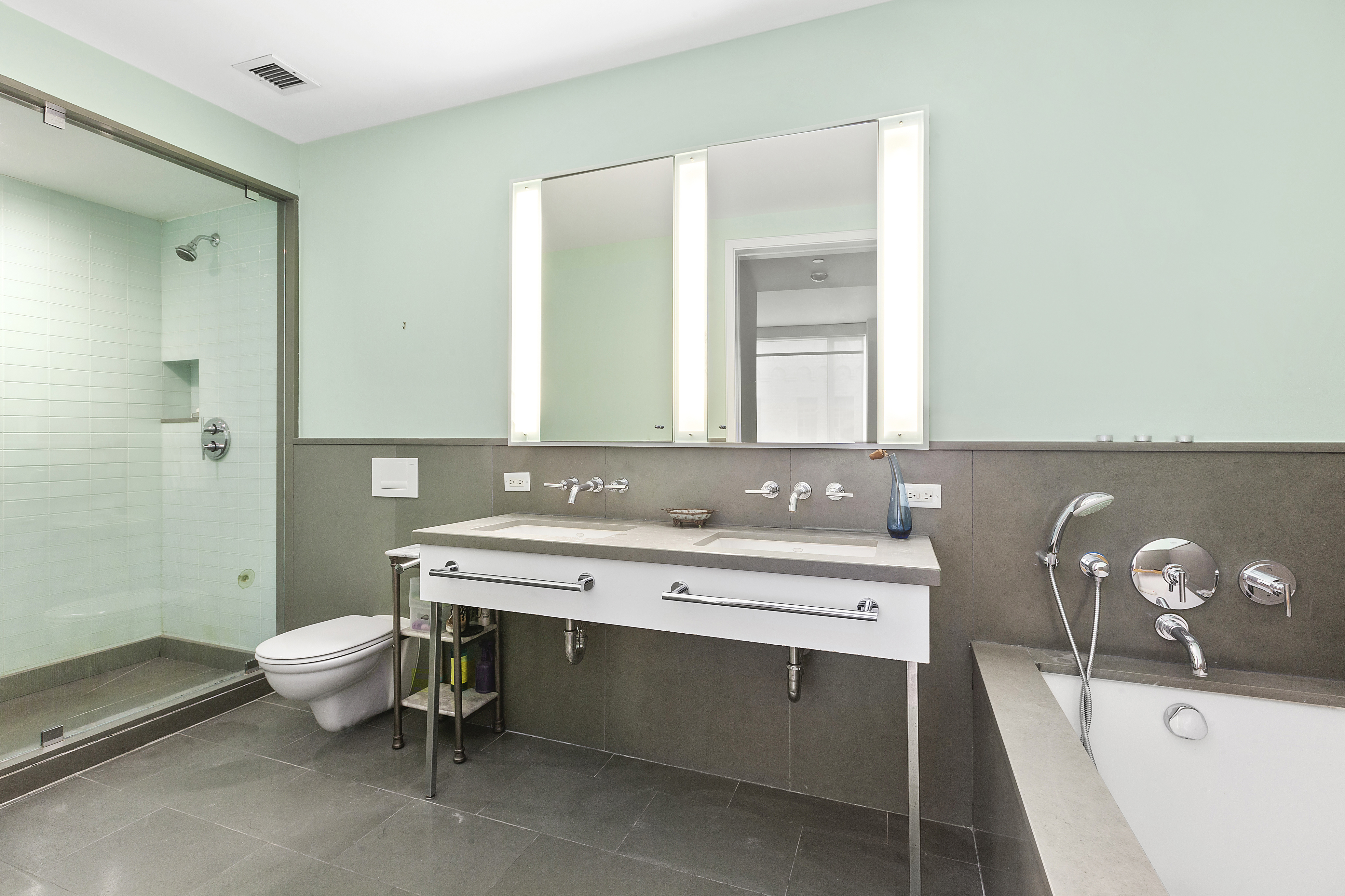 330 Spring Street, Unit 9C Manhattan, NY 10013 - Photo 5 of 8 a bathroom with a sink and a mirror