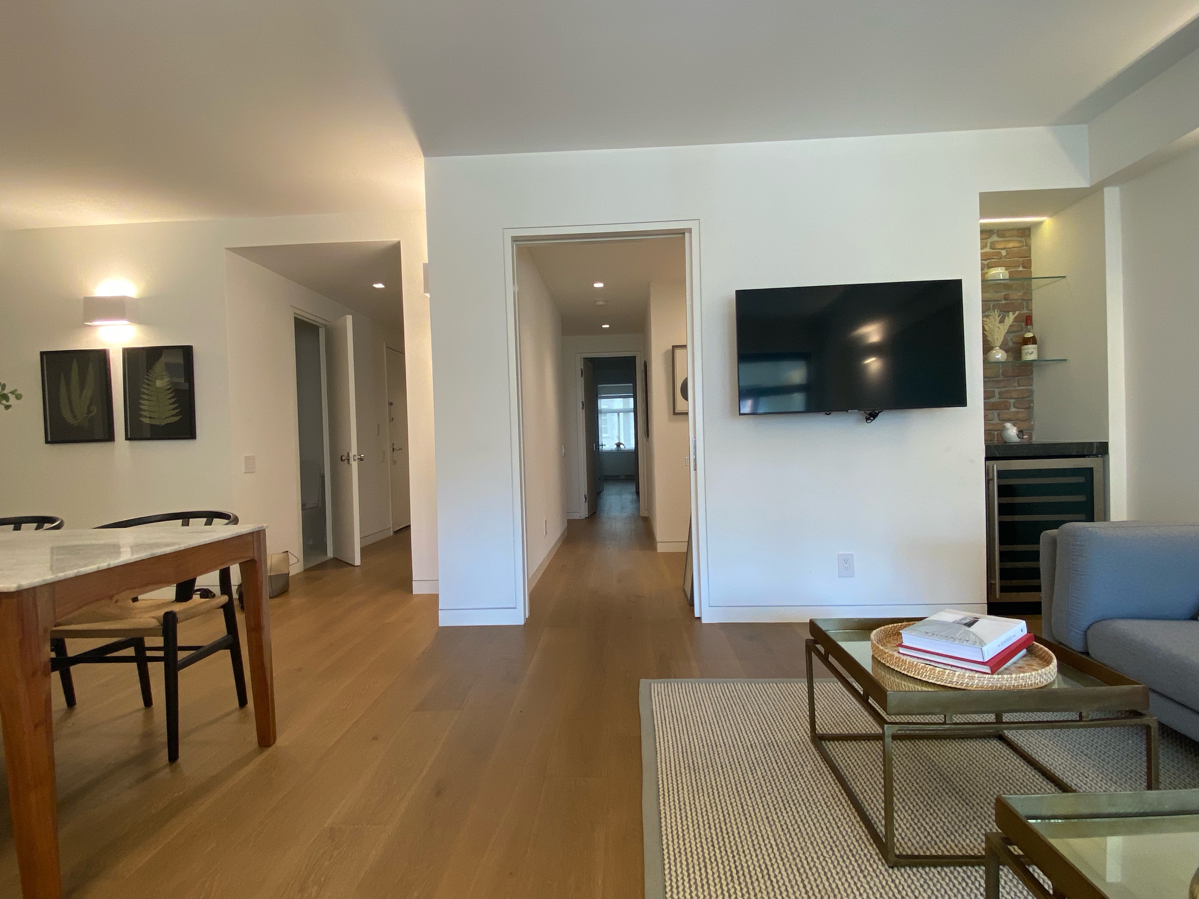 124 East 79th Street, Unit 7D Manhattan, NY 10075 - Photo 3 of 25 a living room with furniture and a flat screen tv
