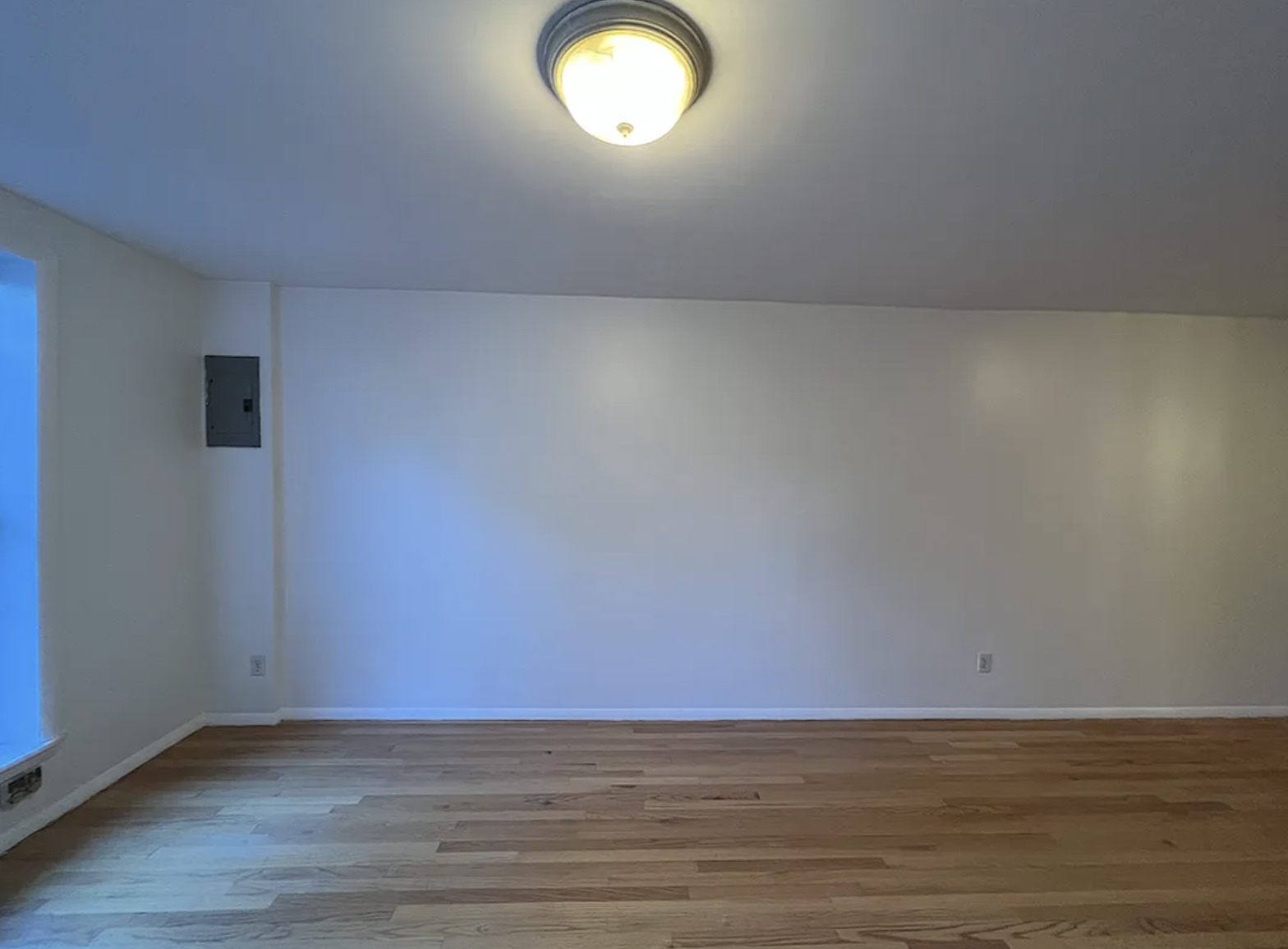 446 West 46th Street, Unit 12 Manhattan, NY 10036 - Photo 6 of 18 a view of an empty room and wooden floor