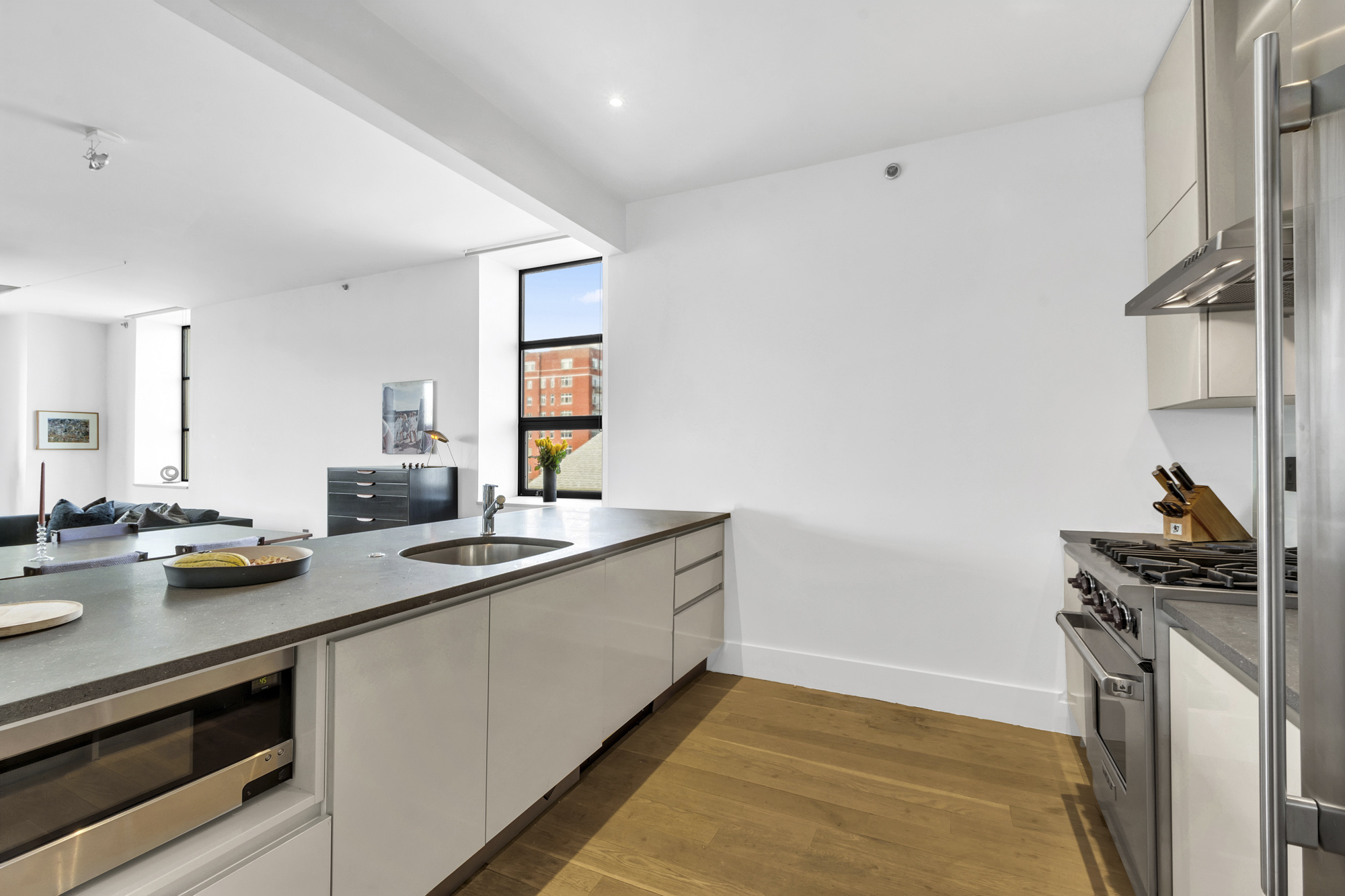 267 West 124th Street, Unit 6A Manhattan, NY 10027 - Photo 10 of 24 a kitchen with a sink and appliances